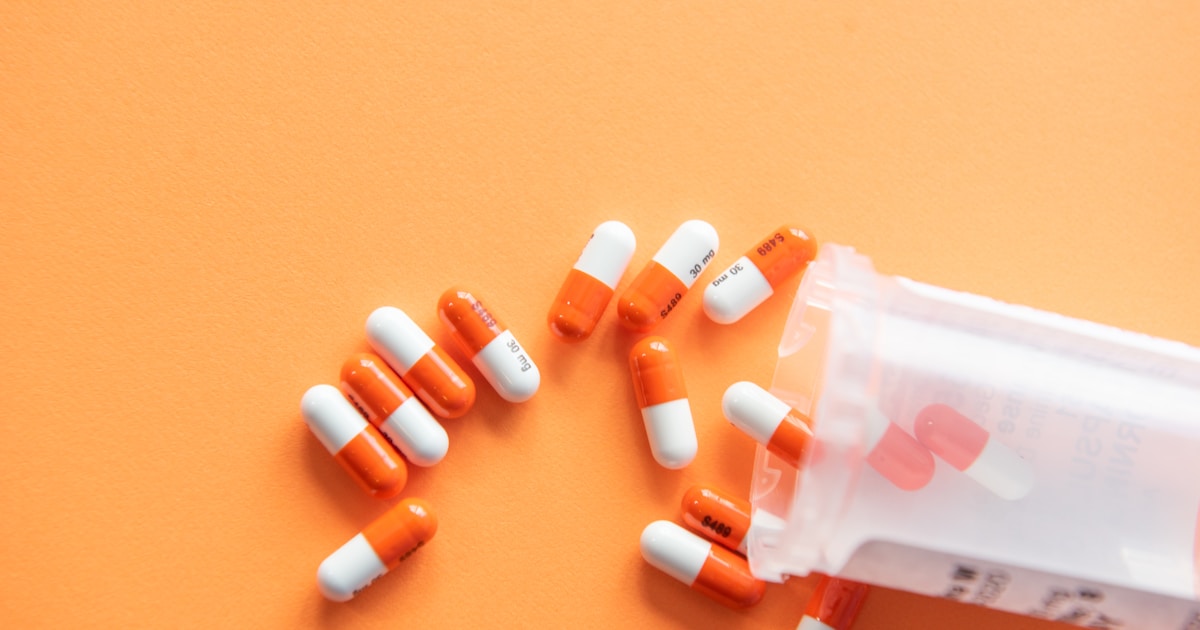A simple medication bottle on a windowsill at dawn — the quiet, evidence-based middle path between unmanaged withdrawal and untreated addiction